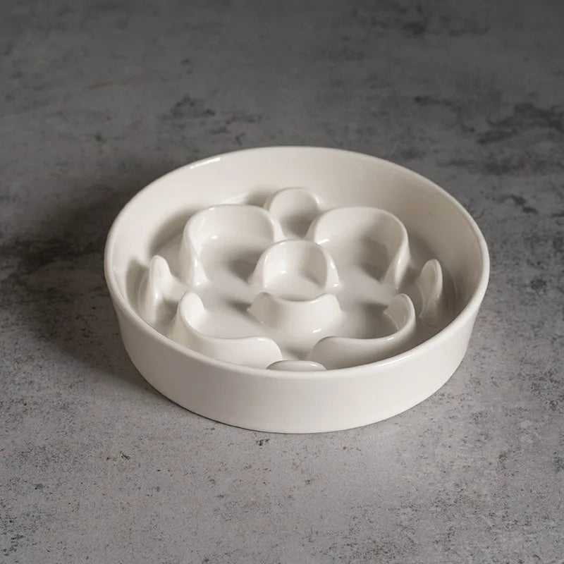 White ceramic slow feeder bowl with flower pattern, seen from above